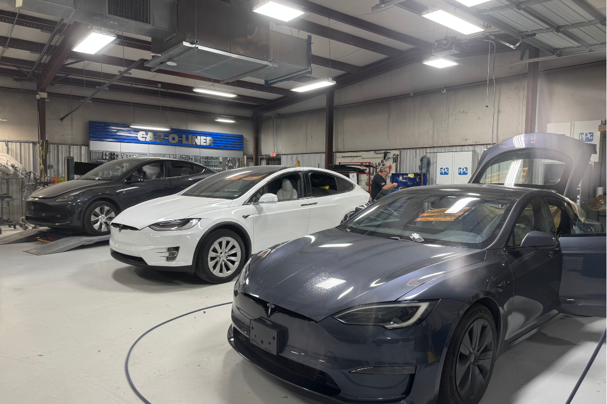 Technician working on Tesla collision repair at Easley body shop